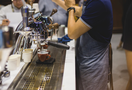 Close-up of espresso pouring from coffee machine. Professional coffee brewing
