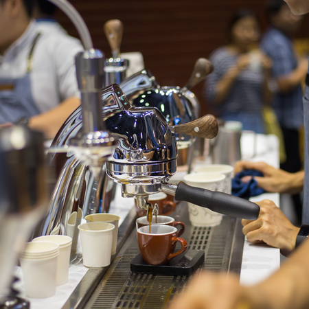 Close-up of espresso pouring from coffee machine. Professional coffee brewingの写真素材