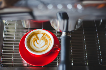 a cup of latte art are ready to serve from the espresso machineの写真素材