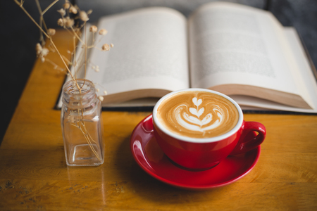 Coffee and book on wood tableの写真素材
