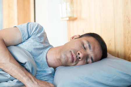 Asian man sleeping on bed in his room and happyness sleep