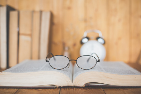 Closeup of reading glasses on the book.の写真素材