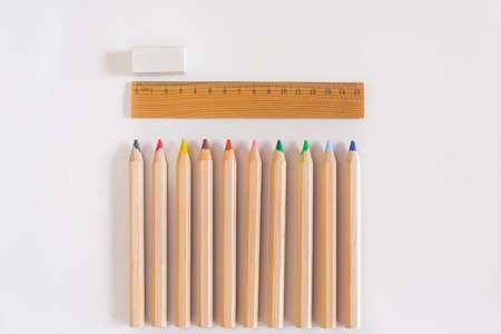 Wood ruler and pencil with rubber  on the white backgruondの写真素材