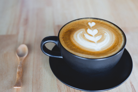 Cup of coffee latte on wood barの写真素材