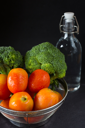 Fresh organic vegetables with bottle of water - health and diet conceptの写真素材