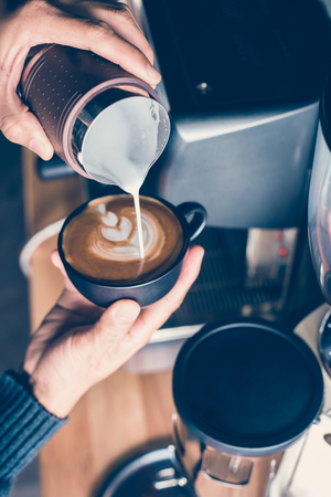 how to make latte art by barista focus in milk and coffeeの写真素材