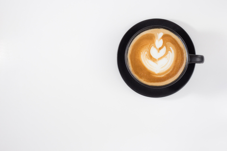 A cup of coffee latee on black cup in white background isolate , Top viewの写真素材