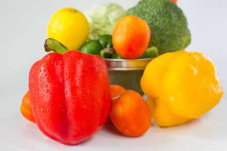 Red bell paprika with another fresh vegetable on white backgroundの写真素材