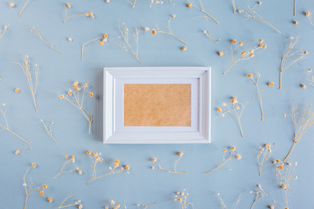 Empty picture frame with dried flower, top view