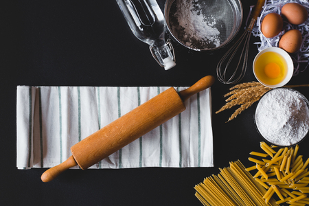 Pasta cooking ingredients on table kitchen table. Top view with space for your textの写真素材