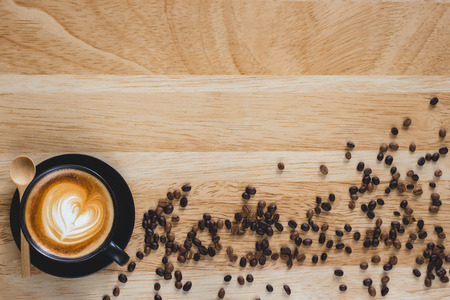 coffee latte art with heart shape on wood background , flat lay with copy space for your textの写真素材