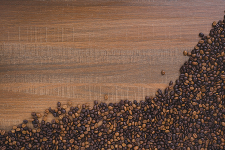 Coffee beans on wood background with copy space for your textの写真素材