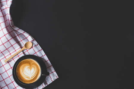 coffee latte art with heart shape on black stone background , flat lay with copy space for your textの写真素材