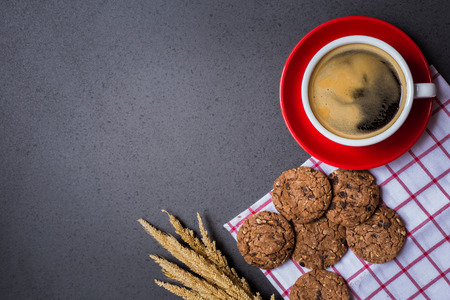 Coffee cup with chocolate cookie on dark stone table background , flat lay image with copy space for your textの写真素材