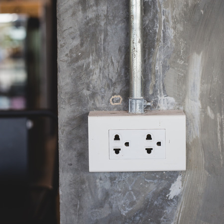 Power socket on stone pillar in cafe , service device for customer in coffee shop