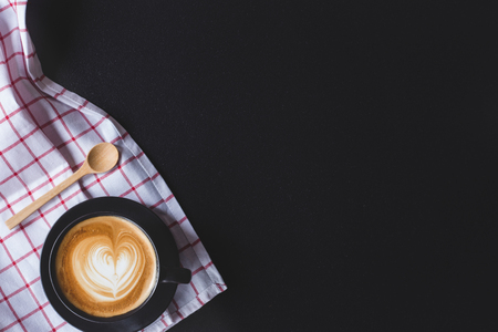 coffee latte art with heart shape on black stone background , flat lay with copy space for your textの写真素材