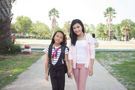 Outdoor portrait of a schoolgirl and her teacher.の写真素材