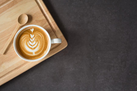 A cup of latte or  cappuccino top view, on wooden plate , image blank space for your textの写真素材