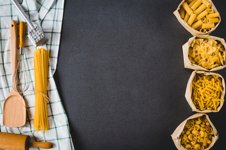 Various pasta in bag with kitchen accessories ,Cooking concept. Top view with space for your recipeの写真素材