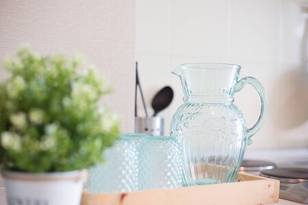 Empty Glass bottle of water with drinking glass  on the table in kitchenの写真素材
