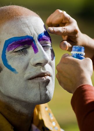 MONTEVIDEO, URUGUAY - FEBRUARY 1: A carnaval participant has his face covered with makeup prior to participating in the annual national festival of Uruguay のeditorial素材