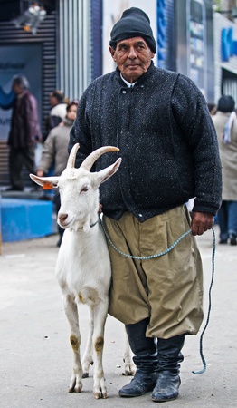  MONTEVIDEO , URUGUAY  - SEP 13 2008 :  Uruguayan farmer with his goatのeditorial素材