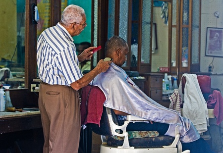 Caragenas de Indias , Colombia - December 21 2010 : Colombian man getting his hair cut in an old fashioned barber shopのeditorial素材