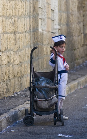 JERUSALEM - MARS 09 : Ultra Orthodox costumed firl during Purim in Mea Shearim Jerusalem on Mars 09 2012 , Purim is a Jewish holiday celebrates the salvation of the jews from jenocide in ancient Persia のeditorial素材