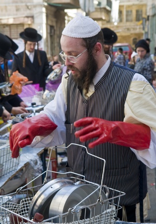 JERUSALEM - APRIL 05 : An Ultra Orthodox man is preparing to the Jewish holiday of Passover by purifacation of the dishes in Jerusalem Israel on April 05 2012のeditorial素材