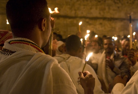 JERUSALEM - APRIL 14 : Ethiopian Orthodox worshipers hold candles during the Holy fire ceremony at...