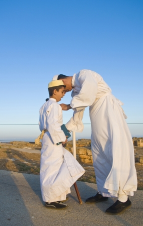 NABLUS, WEST BANK - JUNE 24 : Members of the ancient Samaritan community during the holy day of Shavuot in Mount Gerizim on June 24 2012, Shavuot is an holyday commemoretas the anniversary of the day god have given the Torah to the Israelitesのeditorial素材