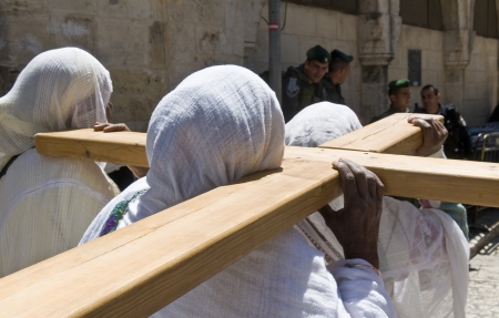 JERUSALEM - APRIL 13 : Ethiopian Christian pilgrims carry across along the Via Dolorosa in Jerusalem...