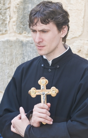 JERUSALEM - APRIL 13 : Russian Orthodox monk carry across along the Via Dolorosa in Jerusalem on April 13 2012 commemorating the path Jesus carried his cross on the day of his crucifixionのeditorial素材