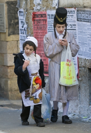JERUSALEM - MARS 09 : Ultra Orthodox costumed boys during Purim in Mea Shearim Jerusalem on Mars 09 2012 , Purim is a Jewish holiday celebrates the salvation of the jews from jenocide in ancient Persia のeditorial素材