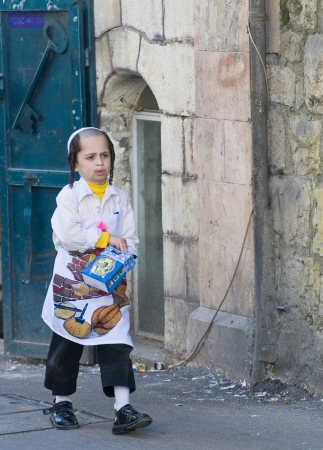 JERUSALEM - MARS 09 : Ultra Orthodox costumed boy during Purim in Mea Shearim Jerusalem on Mars 09 2012 , Purim is a Jewish holiday celebrates the salvation of the jews from jenocide in ancient Persia のeditorial素材