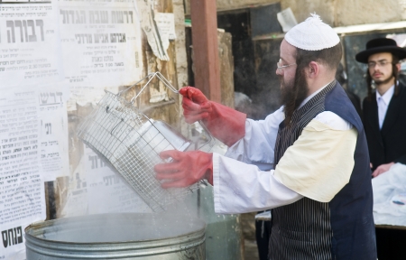 JERUSALEM - APRIL 05 : An Ultra Orthodox man is preparing to the Jewish holiday of Passover by purifacation of the dishes in Jerusalem Israel on April 05 2012のeditorial素材