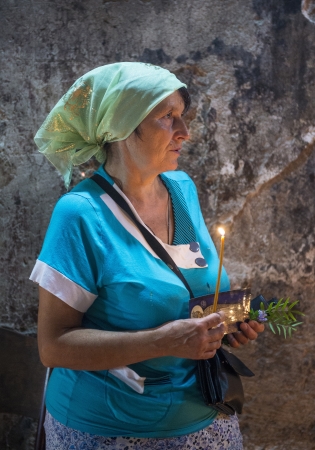 JERUSALEM - AUGUST 25 : Unidentified pilgrim prays in the Tomb of Mary in Gethsemane during the feast of the Assumption of the Virgin Mary on August 25 2012 in old Jerusalem Israel のeditorial素材
