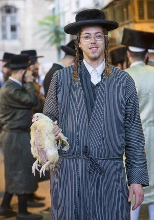 JERUSALEM - SEP 25 : An ultra Orthodox Jewish man holds chicken during the Kaparot ceremony held in Jerusalem Israel in September 25 2012 のeditorial素材