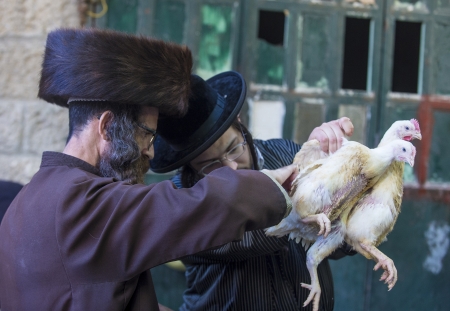 JERUSALEM - SEP 25 : An ultra Orthodox Jewish men holds chickens during the Kaparot ceremony held in Jerusalem Israel in September 25 2012のeditorial素材