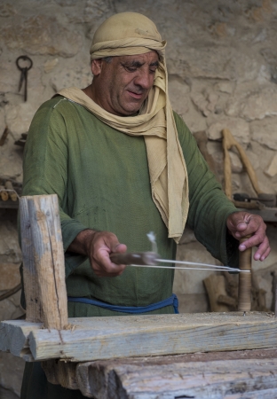 NAZARETH, ISRAEL - OCT 15 : Palestinian carpenter work with traditional tools in October 15 2012 at Nazareth Village, historical re-creation of Nazareth as it was at the time of Christのeditorial素材
