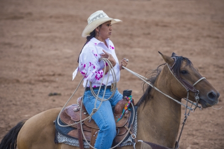 GALLUP , NEW MEXICO - AUGUST 10 : Cowgirl Participates at the 92nd annual Indian Rodeo in Gallup, NM on August 10 2013のeditorial素材