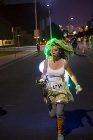 LAS VEGAS - OCT 14 : Runner participates at the GlowRun race in Las Vegas on October 14 2013  , The Glowrun is 5K Annual race where the runners run with glowing and colorful costumesのeditorial素材