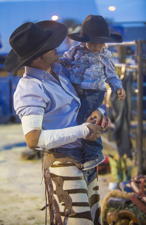 LAS VEGAS - MAY 16 : Cowboy holding his son before the start of the Helldorado days Rodeo , A professional rodeo held in Las Vegas, Nevada on May 16 , 2014 のeditorial素材