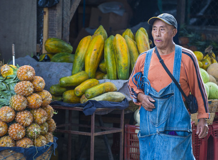 CHICHICASTENANGO , GUATEMALA - JULY 26 : Guatemalan man Sells fruits at the Chichicastenango Market on July 26 2015. This native market is the most colorful in Central Americaのeditorial素材