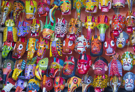 Mayan wooden masks for sale at Chichicastenango market in Guatemala.のeditorial素材