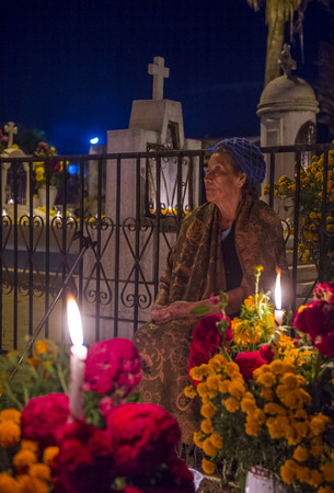 OAXACA , MEXICO - NOV 02 : Unidentified woman on a cemetery during Day of the Dead in Oaxaca, Mexico on November 02 2015. The Day of the Dead is one of the most popular holidays in Mexicoのeditorial素材