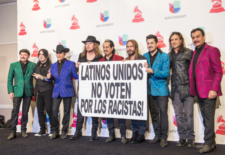 LAS VEGAS , NOV 19 : Members of the music groups Mana and Los Tigres Del Norte hold up a sign in the press room during the 16th Annual Latin GRAMMY Awards on November 19 2015 in Las Vegas, Nevadaのeditorial素材