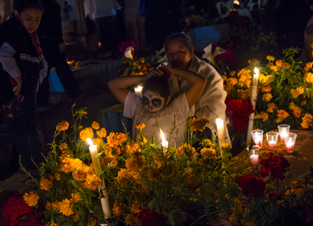 OAXACA , MEXICO - NOV 02 : Unidentified people on a cemetery during Day of the Dead in Oaxaca, Mexico on November 02 2015. The Day of the Dead is one of the most popular holidays in Mexicoのeditorial素材