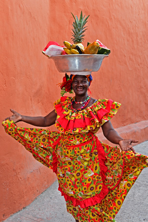 CARTAGENA , COLOMBIA - FEB 04 : Palenquera woman sell fruts in Cartagena ,Colombia on Februery 04 2016. Palenqueras are a unique African descendat ethnic group found in the north region of South Americaのeditorial素材