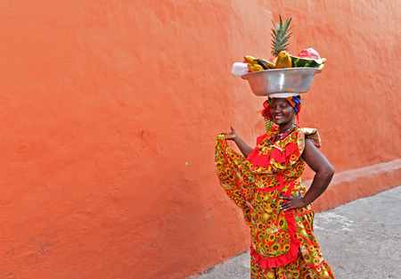 CARTAGENA , COLOMBIA - FEB 04 : Palenquera woman sell fruts in Cartagena ,Colombia on Februery 04 2016. Palenqueras are a unique African descendat ethnic group found in the north region of South Americaのeditorial素材